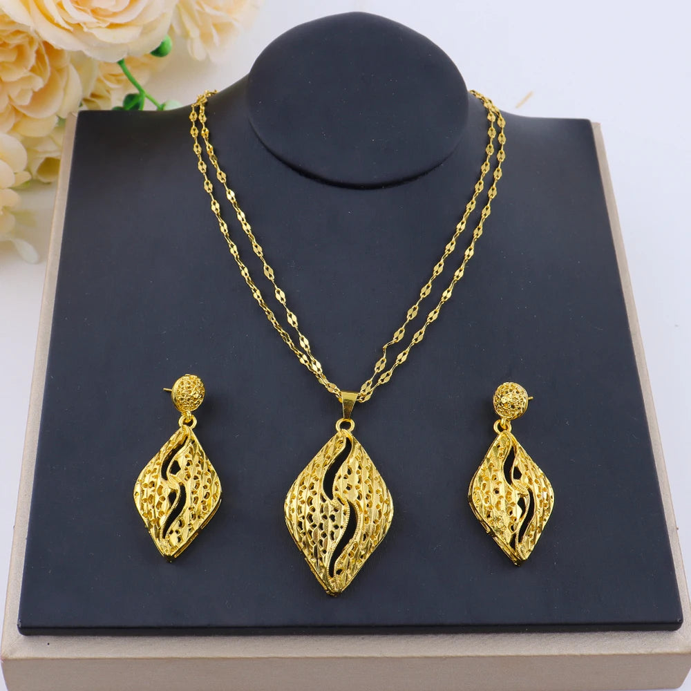 Bridal gold plated jewelry set styled on a display bust with flowers
