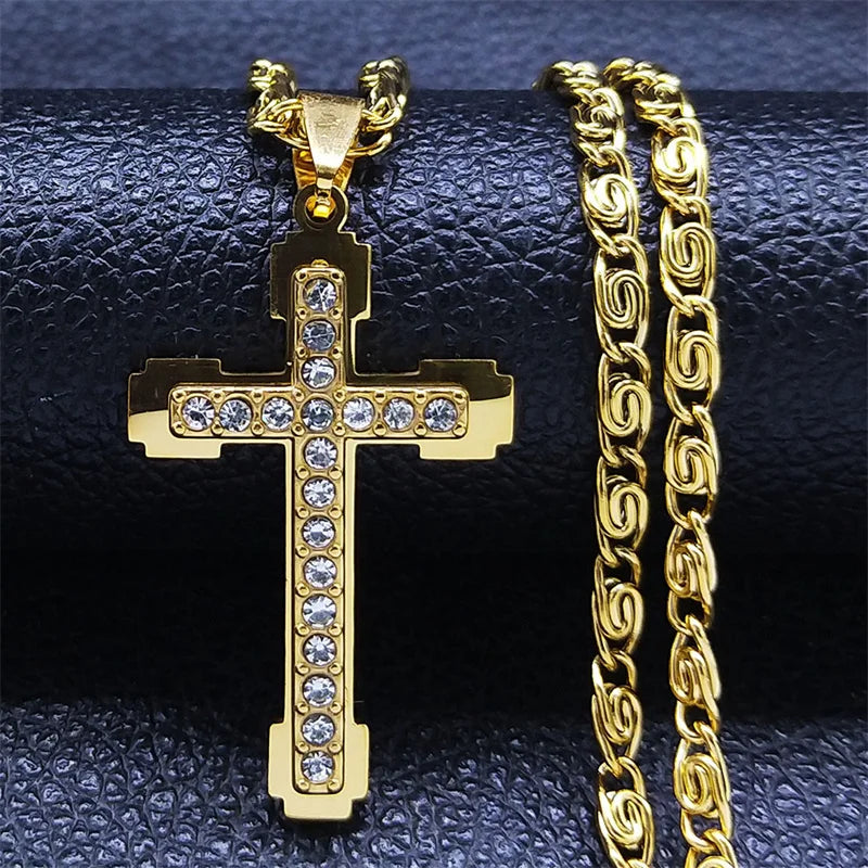 Gold crystal cross pendant necklace with byzantine chain on dark background