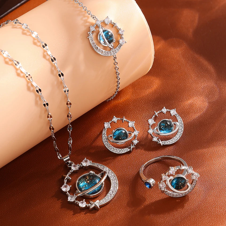 Silver-tone four-piece set with planet necklace, stud earrings, bracelet and ring