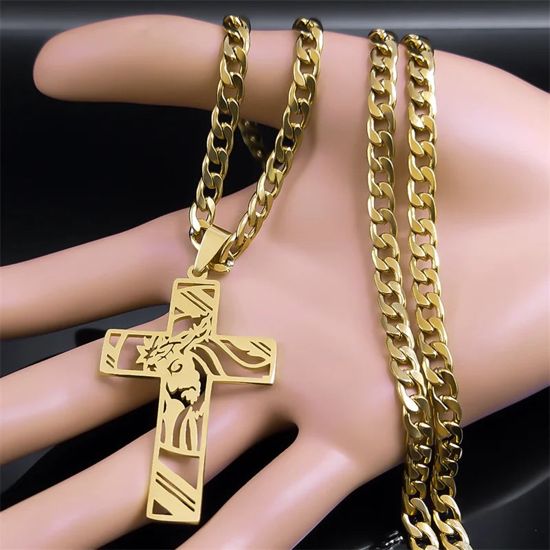 Gold-tone cross pendant necklace displayed on a mannequin hand to show its size