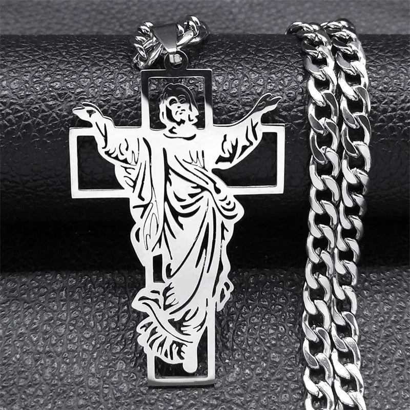 Silver-tone crucifix pendant with the figure of Christ next to a matching silver curb chain