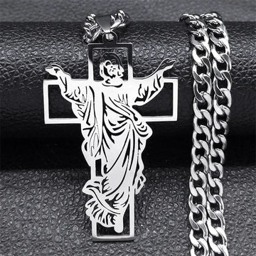 Silver-tone crucifix pendant with the figure of Christ next to a matching silver curb chain
