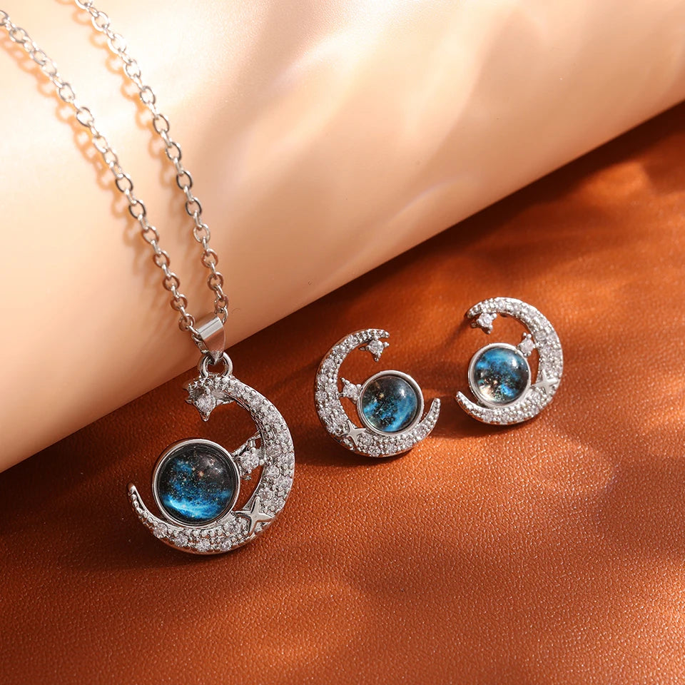 Silver-tone crescent moon necklace with matching moon stud earrings