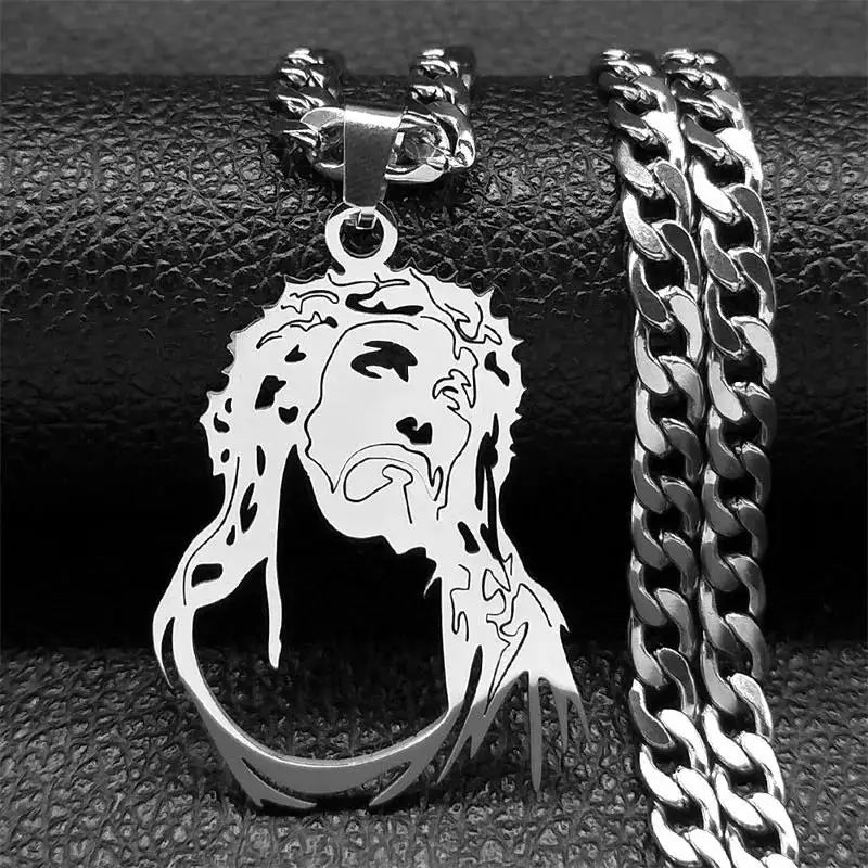 Silver-tone Jesus portrait pendant with crown of thorns next to a silver curb chain