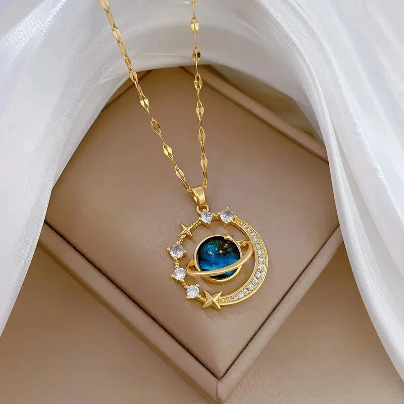 Gold-tone crescent moon and blue planet pendant necklace with zircon stars in a gift box