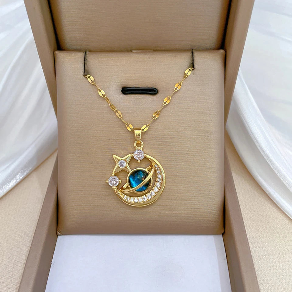 Gold-tone crescent moon and star pendant necklace with a blue stone in a gift box