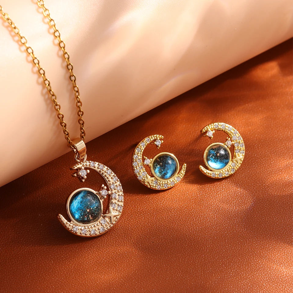 Gold-tone crescent moon planet necklace with matching moon stud earrings