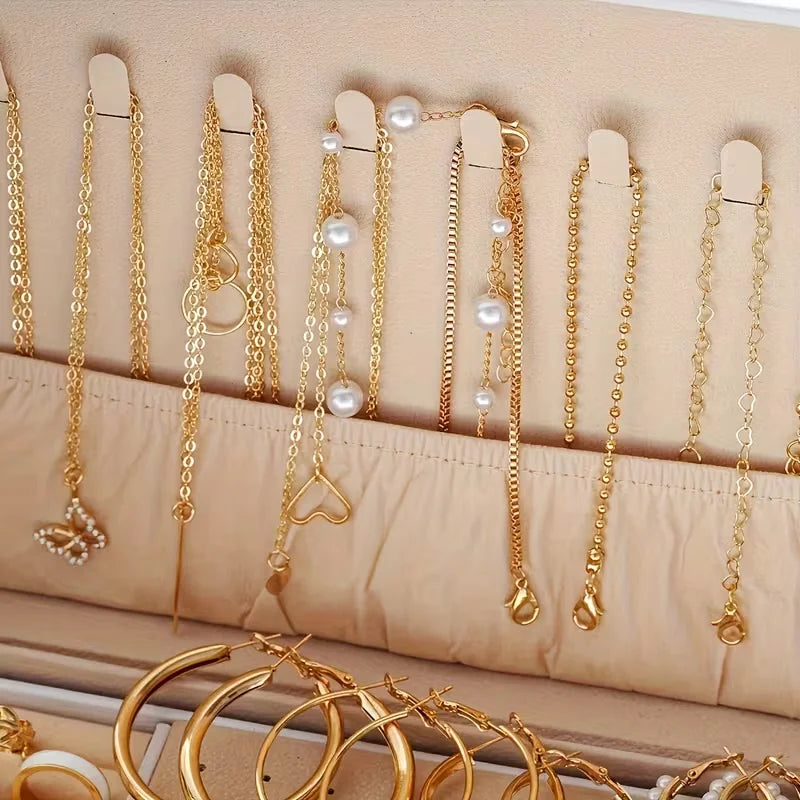 Gold layered necklaces with pearl and heart pendants hanging in a jewelry organizer