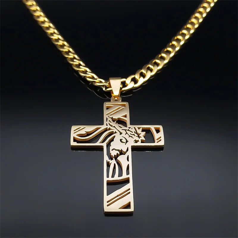 Close-up of the gold-tone Jesus cross pendant hanging from a gold curb chain