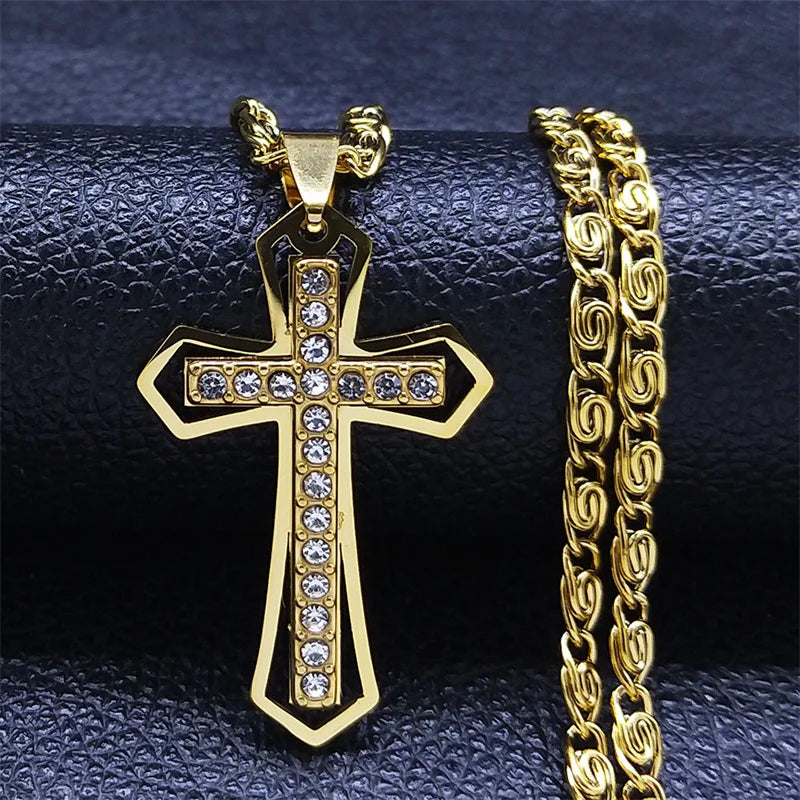 Gold Catholic cross pendant with crystals next to a gold byzantine chain