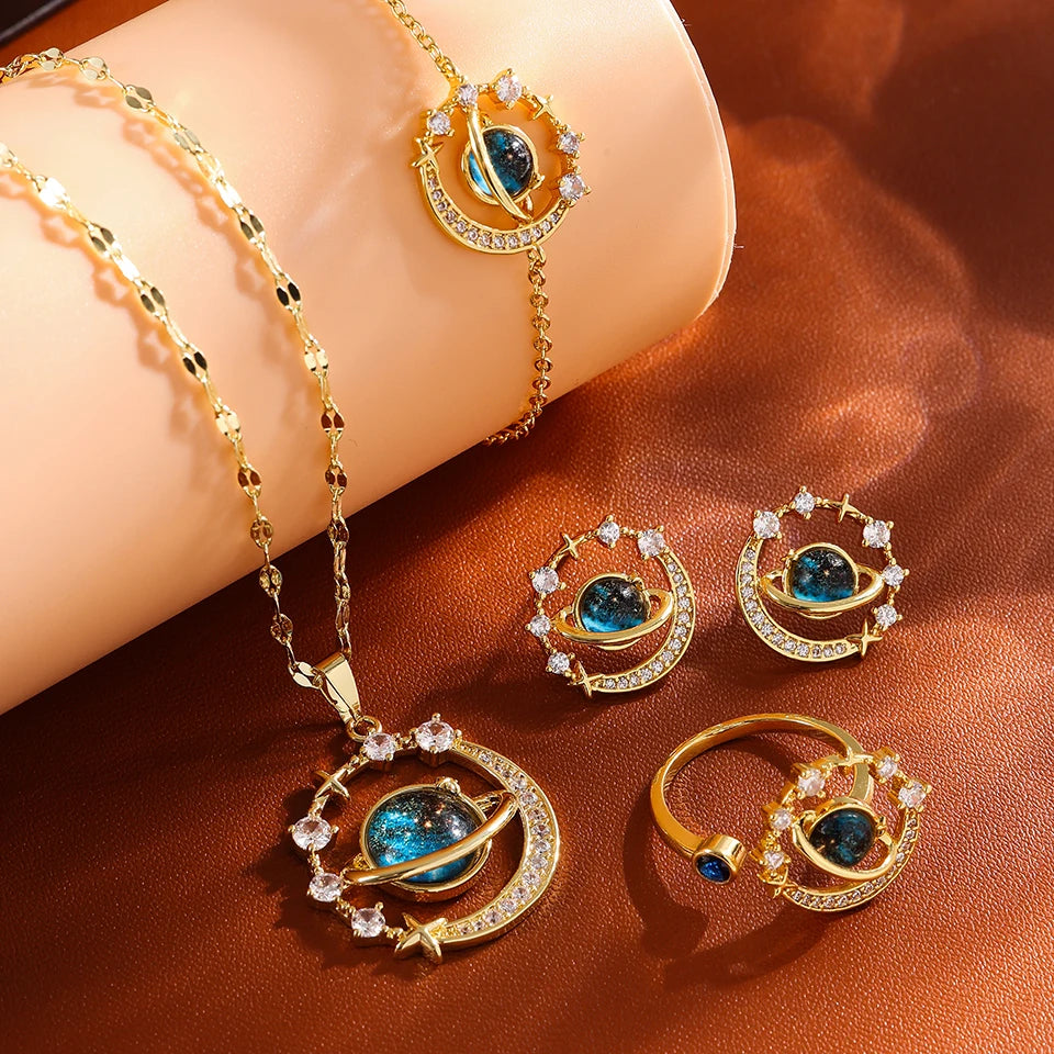 Gold-tone four-piece set with planet necklace, stud earrings, bracelet and ring