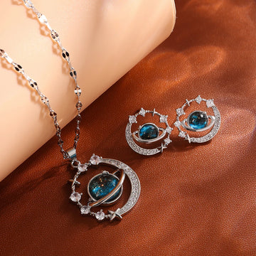 Silver-tone planet and moon pendant necklace with matching stud earrings