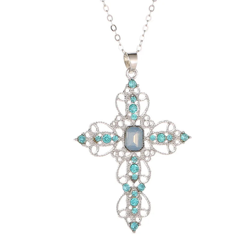 Silver filigree cross pendant necklace set with aqua rhinestones and a pale blue rectangular center stone