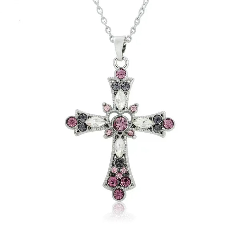Silver cross pendant necklace decorated with pink, black and clear crystals on a silver chain