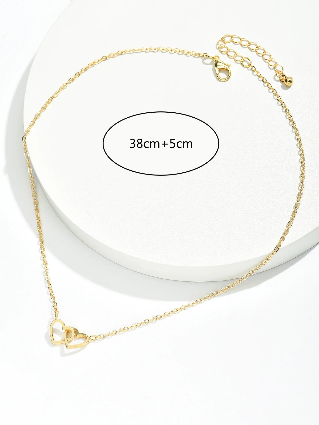 Size diagram labeling the double heart necklace as 38cm plus a 5cm extender