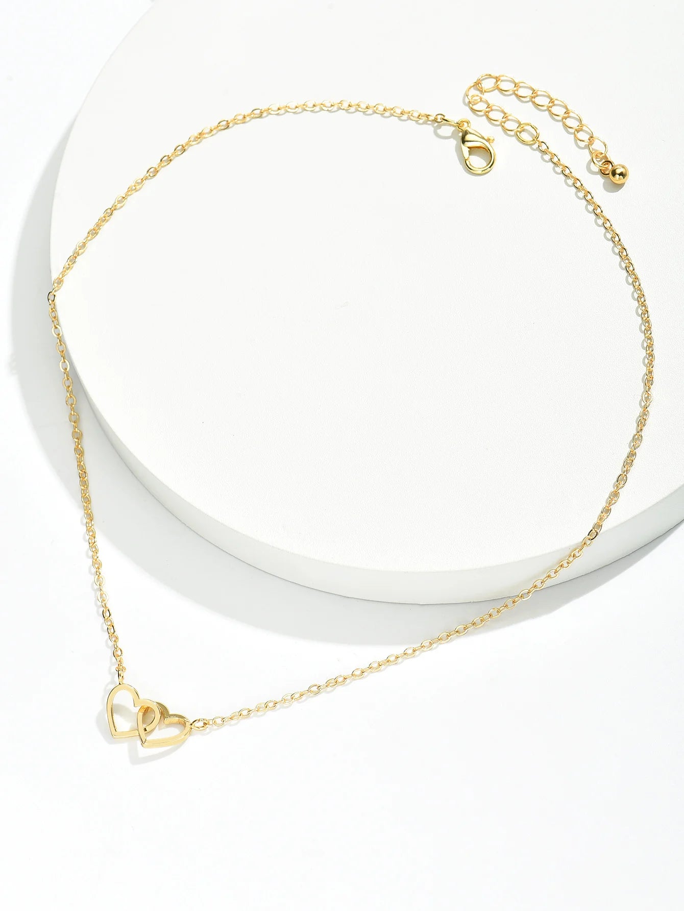 Full gold-tone heart necklace showing the link chain, lobster claw clasp and extender
