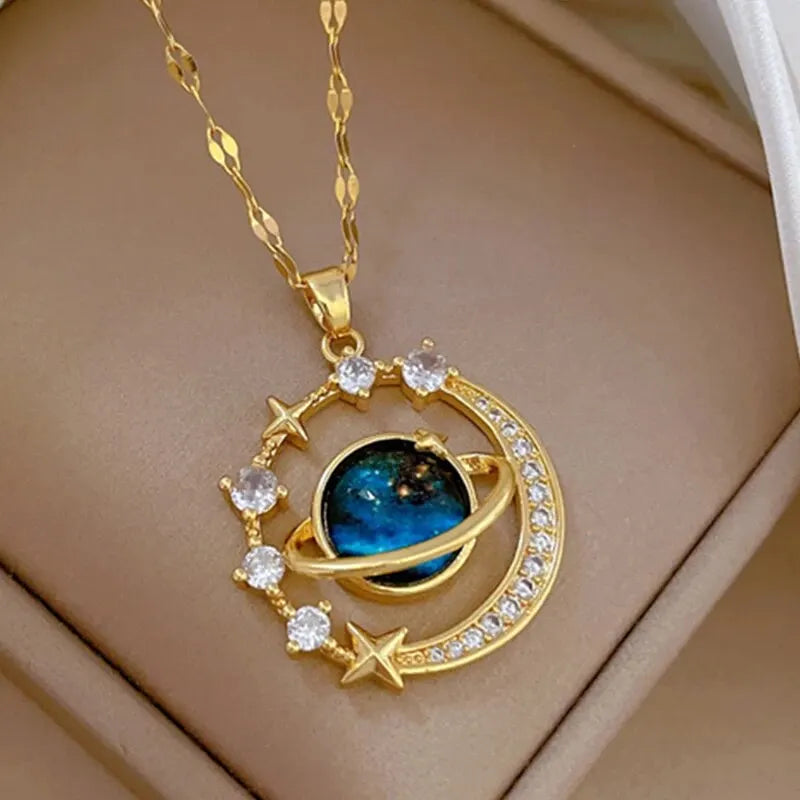 Gold-tone crescent moon and blue planet pendant necklace with cubic zirconia stars