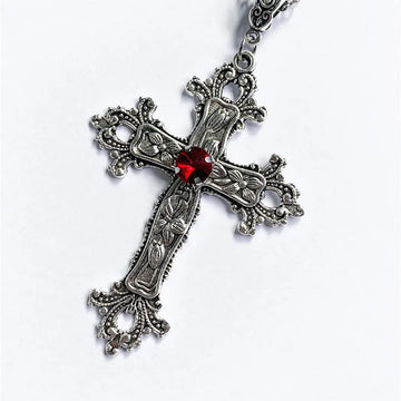 Close up of the large silver baroque cross pendant with a faceted red center stone
